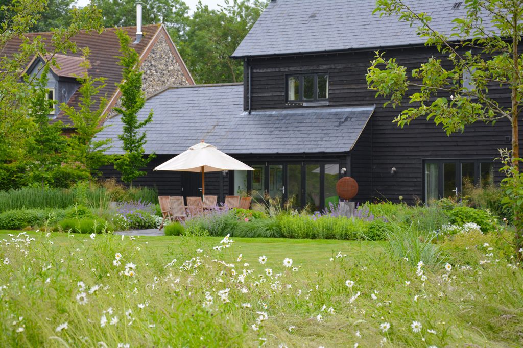 Barn style building with naturalistic garden